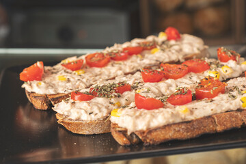 Delicious tuna sandwich with natural organic bread, cherry tomatoes, herbs and spices. Selective focus. 