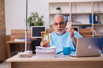 Old male employee in blood transfusion concept