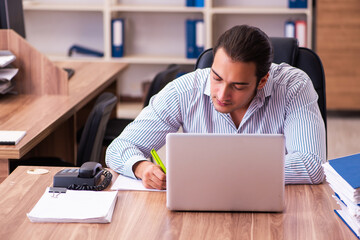 Young male employee working in the office