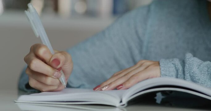 Woman study at home and jot down the note