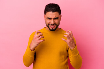 Young mixed race man isolated on pink background