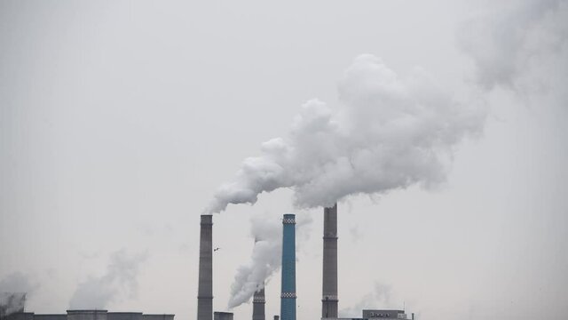 Industrial plant pipes pollute atmosphere &ndash; climate change, pollution concept