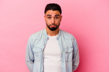 Obraz premium Young mixed race man isolated on pink background
