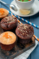 Homemade chocolate cupcake with nuts on the table with tea. Chocolate covered muffin