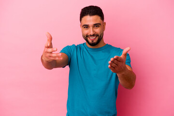 Fototapeta premium Young mixed race man isolated on pink background