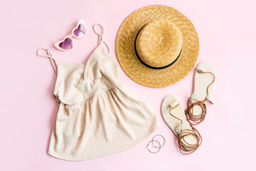 Fashion summer women's clothes set with accessories on pink background, Flat lay, Top view