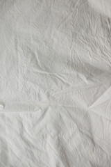 neutral light beige textile, featuring wrinkles and slight folds 