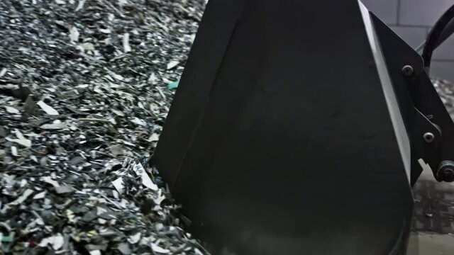 The Backhoe Loader or Excavator takes small particles of plastic with bucket
