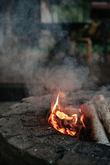 Flame and smoke of fire in the stone hearth
