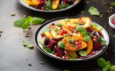 Fried Halloumi Cheese salad with beetroot, orange, pomegranate and pumpkin seeds, red onion, green vegetables. healthy food