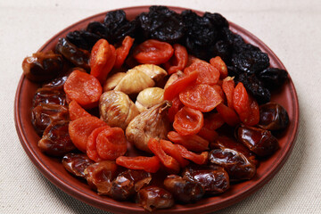 plate with dried fruits, figs, dates, prunes, dried apricots 