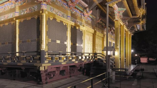 tokyo, japan - april 05 2021: Pan video of the luxurious gold foil Ueno Tosho-gu shrine dedicated to the first Shogun of Edo era Tokugawa Ieyasu and classed as Important cultural property at night.