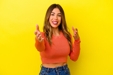 Young caucasian woman isolated on yellow background