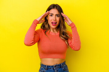 Young caucasian woman isolated on yellow background