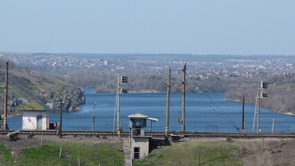 view of the river behid the railway and semaphors