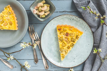 Piece of rhubarb pie on gray rustic wooden background, top view