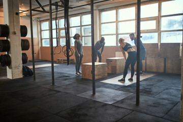 People taking a break from a box jump workout session