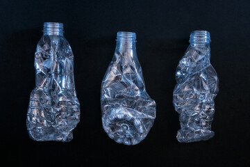 Separate waste collection. Plastic, glass, aluminum on a black background.