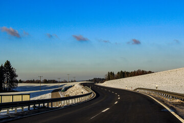 Curvy road through a snowy field