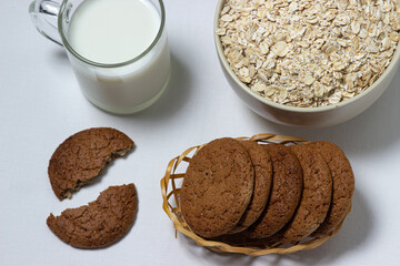 A glass of milk and oatmeal cookies on a white background. Diet food. Light breakfast