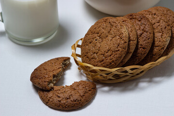 A glass of milk and oatmeal cookies on a white background. Diet food. Light breakfast