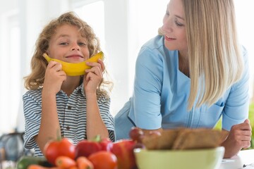 Little boy playing with fruit during a visit to a dietitian