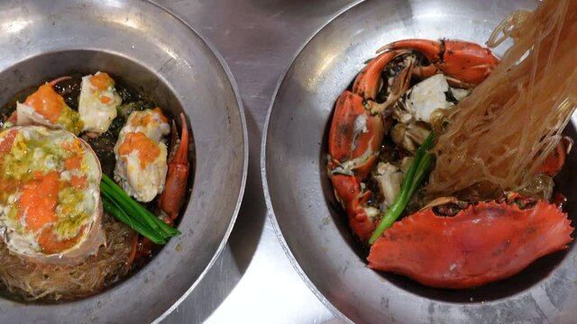 Eating Thai chinese style seafood dish steamed pot with crab and vermicelli glass noodle
