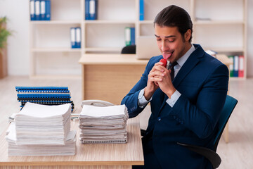 Young male employee unhappy with excessive work
