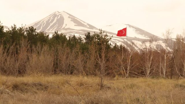 Travel turkey.
Turkey flag appears flying in the forest in the spring in Erzurum.
patriotism.
Temperature in Erzurum could reach -50°C in the winter.
Snow covered mountains.
Beautiful natural scene