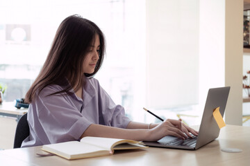 Online education. Asian girl online lesson using a computer video call to a virtual teacher at home