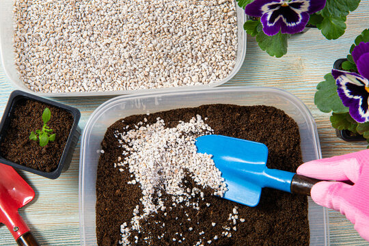 Mixing perlite granules pellets with black gardening soil improves water retention, airflow, aeration, root growth capacity of all the plants growing in pots.  Perlite is an amorphous volcanic glass.