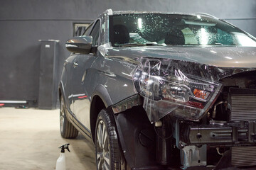 Installation of a protective paint and varnish transparent film on the car. PPF polyurethane film to protect the car paint from stones and scratches.