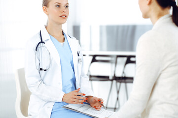 Woman - doctor consults her female patient in clinic. Medicine concept