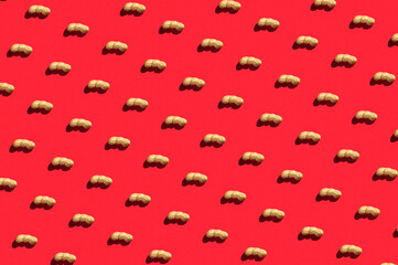 Pattern of peanuts with shell. Fashionable sunny pattern of peanuts with shell on a bright red background. Colorful pattern. View from above