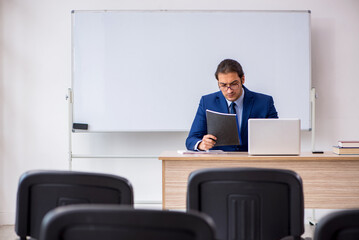 Young male business trainer in the office during pandemic