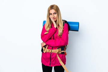 Young mountaineer woman with a big backpack over isolated white background unhappy and frustrated