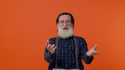 Happy joyful senior old bearded gray-haired man laughing out loud after hearing ridiculous anecdote, funny joke, feeling carefree amused, positive people lifestyle. Elderly grandfather pensioner