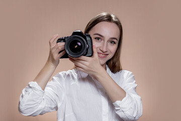 Young happy girl takin pictures with digital camera. Work, people, hobby, lifestyle, technology, studying concept