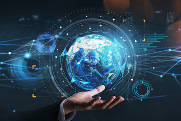 Businessman holding on his hand a hologram of planet Earth. Concept of fintech industry at international business. Globe and tech interface. Elements of this image furnished by NASA