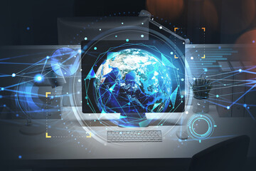 Blue futuristic hud interface with planet Earth over display screen of desktop computer on office workspace. Elements of this image furnished by NASA