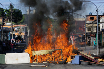 Residents set a barricade on fire to protest the constantly floods on their neighborhood during...