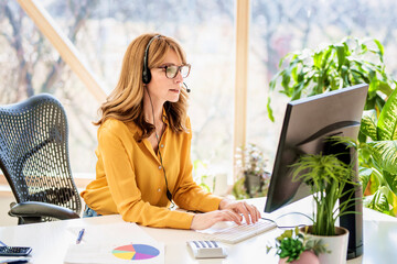 Shot of call center agent businesswoman working from home