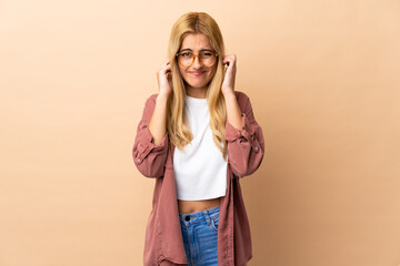 Young Uruguayan blonde woman over isolated background frustrated and covering ears