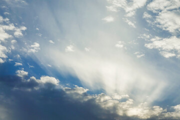 Naklejka na ściany i meble Blue sky with clouds and sunbeams