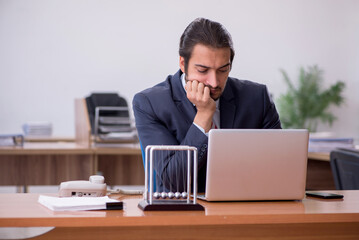 Young man businessman employee sitting in the office