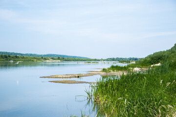 View of the Oka river from the shore, the opposite Bank is visible . The sky is reflected in the water