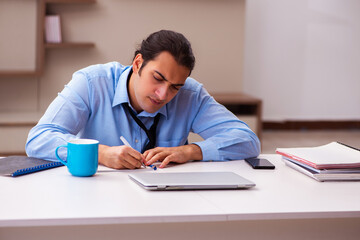 Young male employee working from home during pandemic