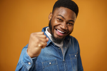 Happy excited african american young man celebrating success