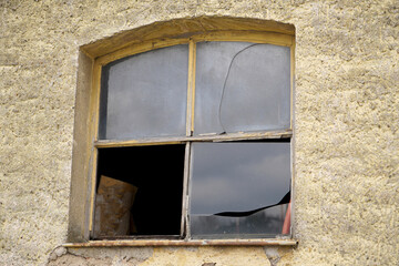 Old wooden frame and broken glass window on an old building for renovation