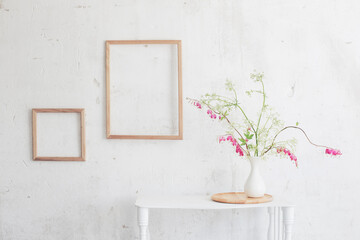 Fototapeta na wymiar flowers in vase on background white wall
